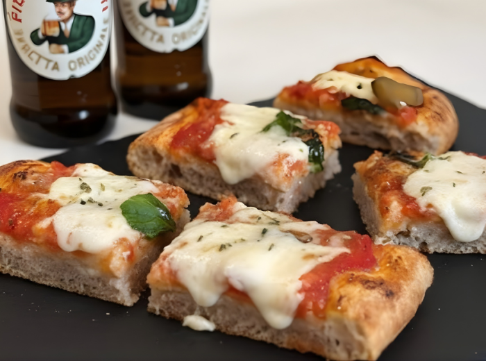 Freshly baked pizza al taglio with rosemary and olive oil