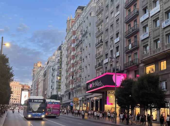 Gran Vía at night with theater marquees and neon signs lit
