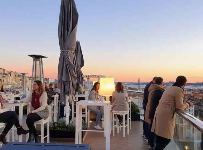 Hotel Mundial rooftop bar with drinks and city view at dusk