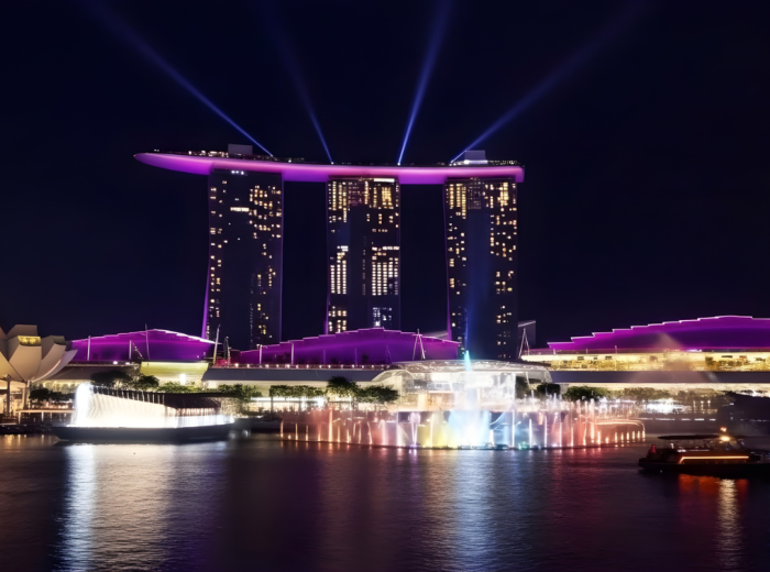 Evening light reflecting off Marina Bay towers from the waterfront path