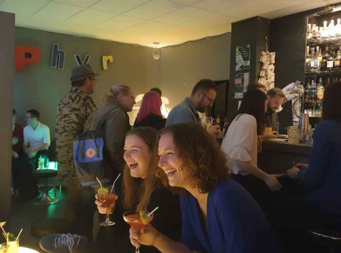 Cozy bar interior in Glockenbach with locals chatting at small tables