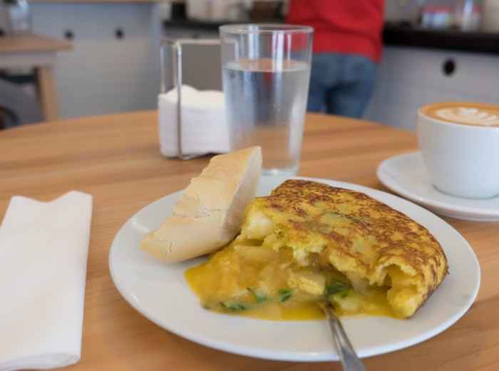 Slice of runny tortilla española with potatoes 