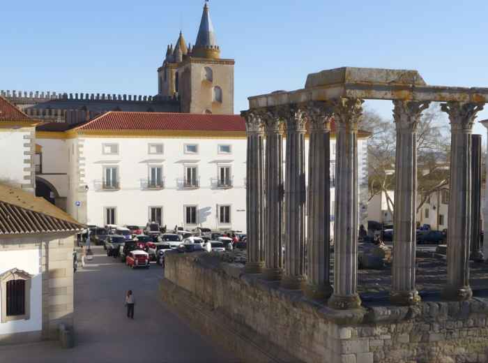 Roman Temple columns standing in Évora's main square at sunset