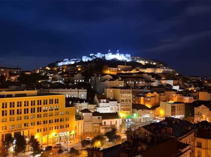 Convent of Christ medieval walls towering over Tomar rooftops