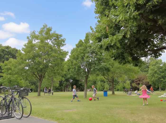 Jarry Park green space with people picnicking and children on the grass