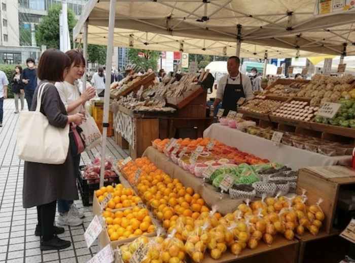UNU Farmers Market in Aoyama with local vendors selling fresh produce and baked goods