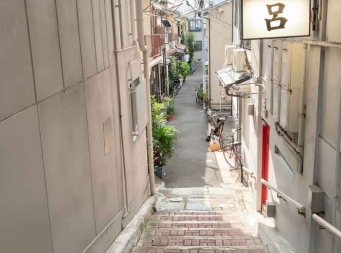 Narrow stone stairway alley in Karahori with metal handrails