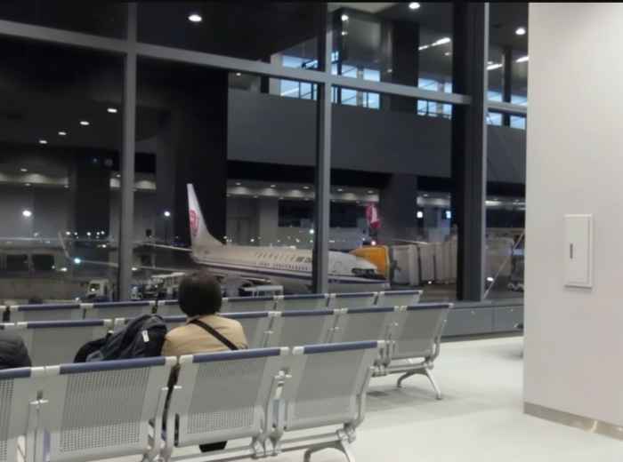 Passengers waiting inside a Japanese international airport terminal