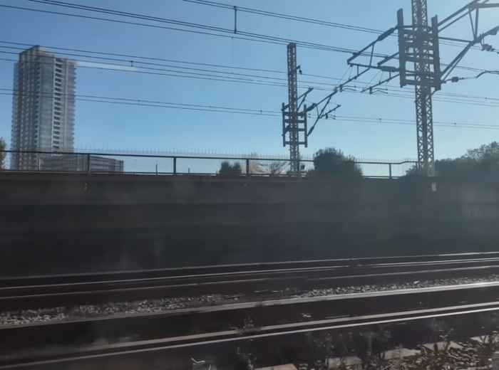 Train tracks and power lines seen from a departing train in Tokyo