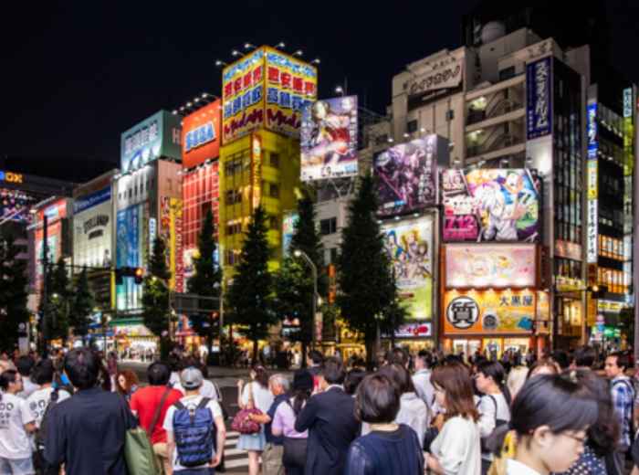 Bustling Akihabara streets at Night with neon signs and billboards