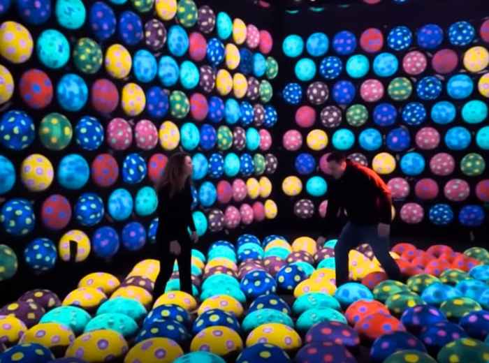 Immersive digital art room glowing in the dark at teamLab Tokyo