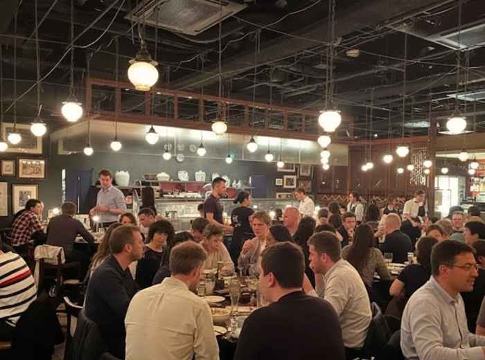 Busy restaurants crowded with tourists at night in Shibuya