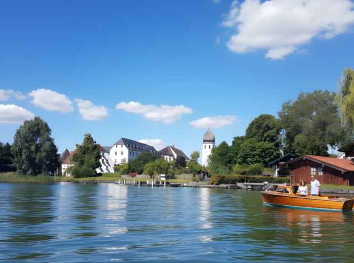 Boat approaching Fraueninsel pier with abbey in view