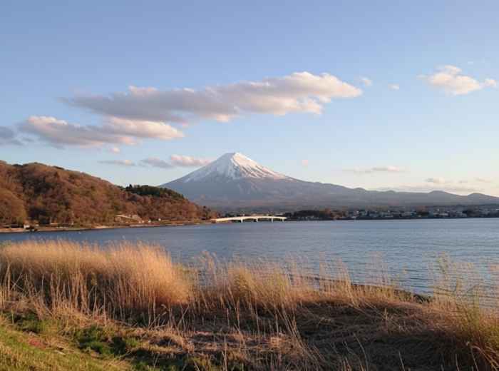 Mount Fuji rising over Lake Kawaguchiko at sunrise with calm waters