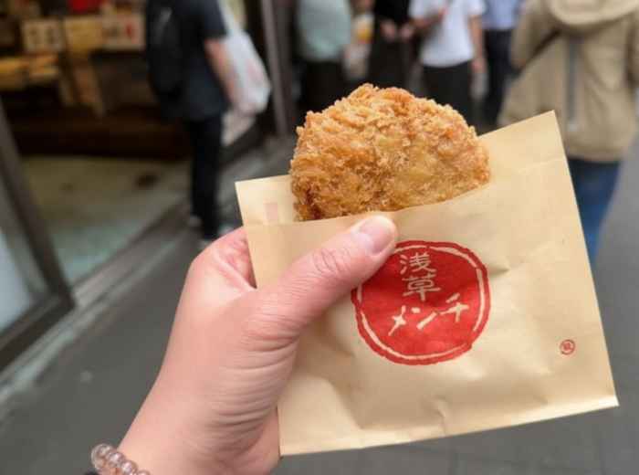 Golden-brown menchi katsu breaded meat patty fresh from the fryer