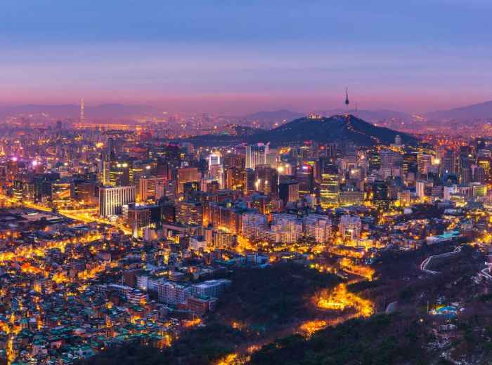 Evening glow across Seoul’s dense neighborhoods and surrounding hills