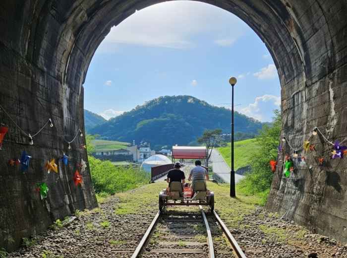 Gangchon rail bike over river with mountains beyond