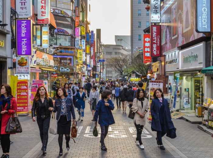 Busy pedestrian street in central Seoul with shop signs