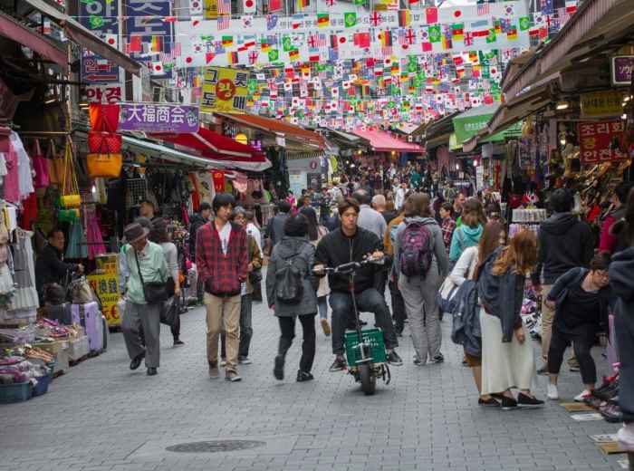 Busy Namdaemun Market street filled with local shoppers and stalls