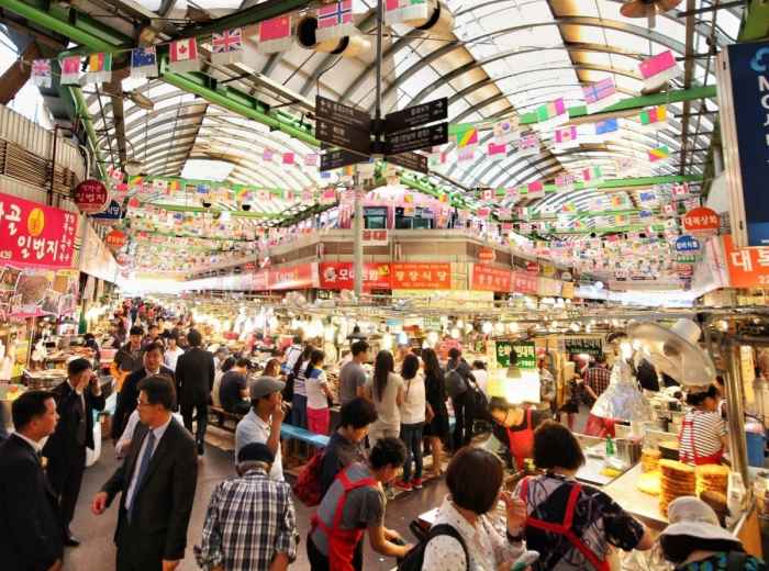 Crowded food stalls inside Gwangjang Market in Seoul