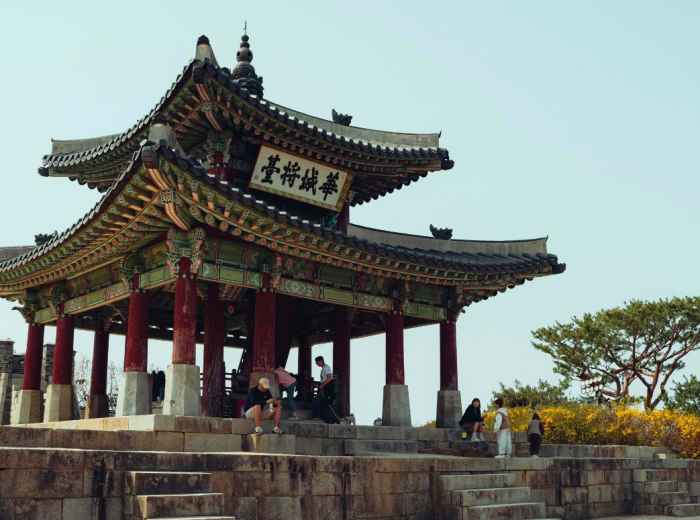 Suwon Hwaseong pavilion with visitors on the stone platform