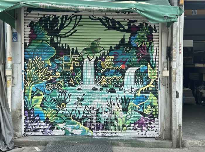 Street mural on metal workshop door in Mullae Art Village