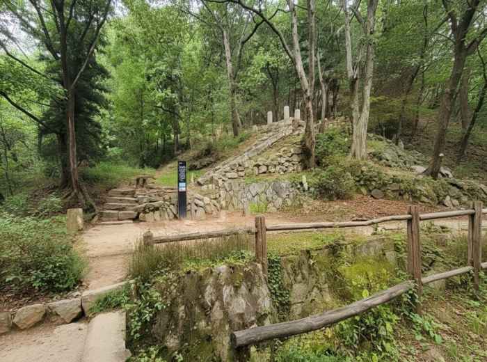 Wooded trail and stone remains in Baeksasil Valley