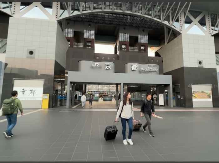 Early morning at Kyoto Station with travelers and luggage