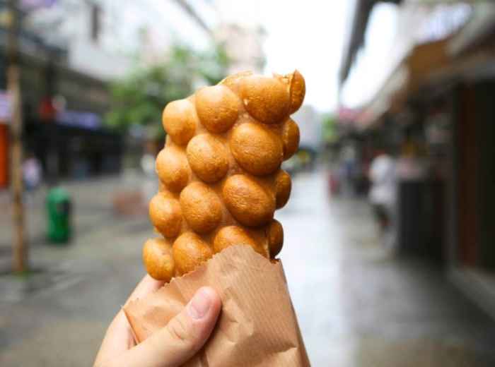 Hong Kong pineapple bun on a small plate in a traditional cha chaan teng