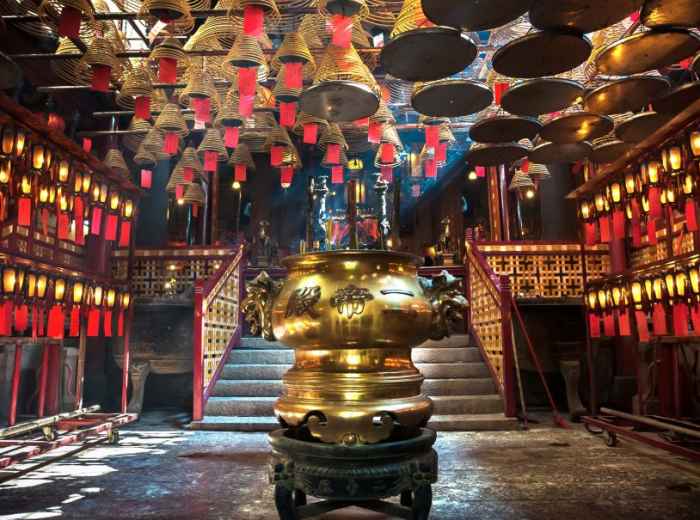 Interior of Man Mo Temple with incense coils and hanging lanterns