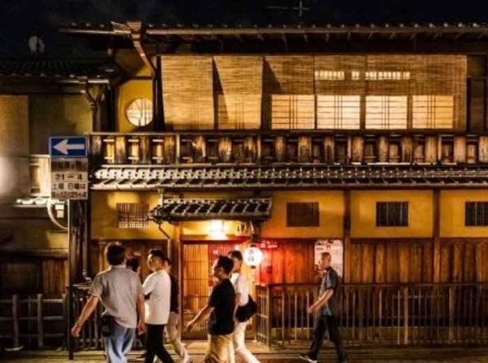 Friends walking through Gion on a warm Kyoto night