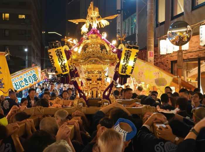 Bettara Ichi at night with a mikoshi procession in Tokyo