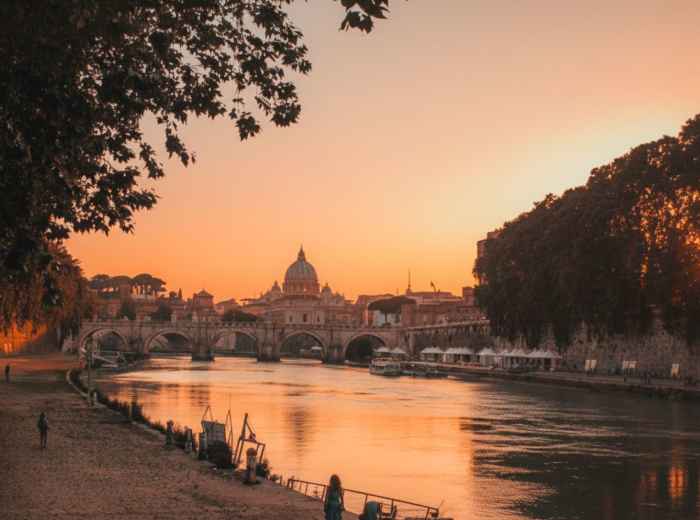 Golden sunset over Rome with St. Peter's dome in the distance