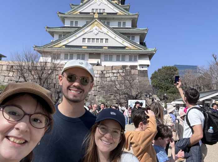 Timea exploring Osaka Castle with guests during a lively day in the city