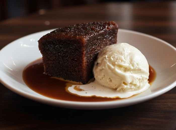 Sticky toffee pudding served with vanilla ice cream and toffee sauce