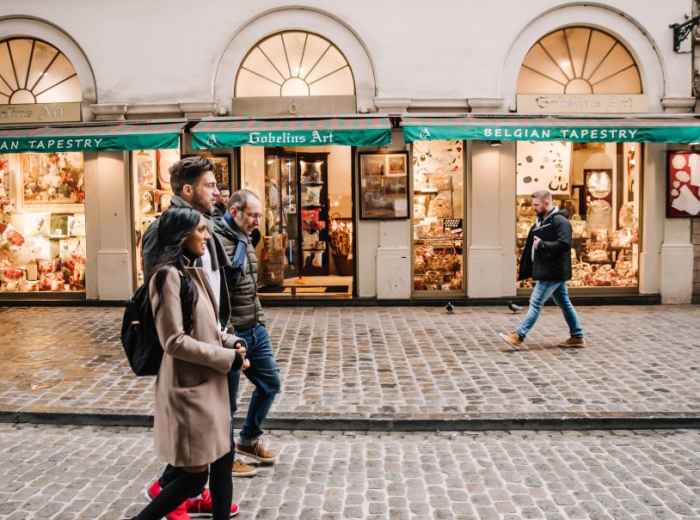 Pedestrians passing chocolate shops in central Brussels
