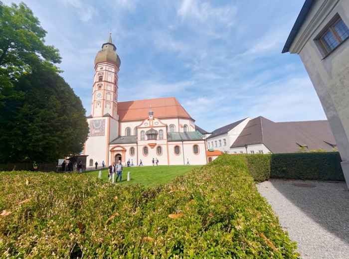 Andechs Monastery rises above the Bavarian countryside beneath a clear blue sky