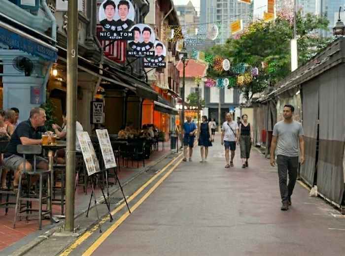 People walking through a Chinatown lane in Singapore 