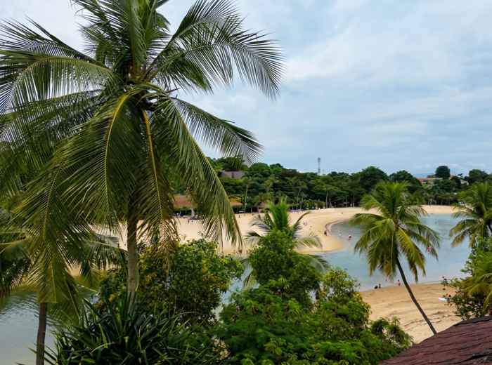 Palm-lined beach and lagoon on Singapore's Sentosa Island 