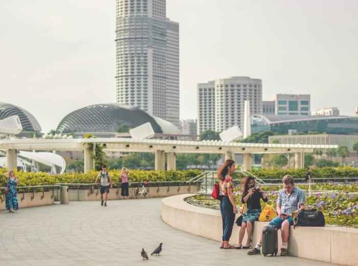 People relaxing in a landscaped public space in central Singapore 