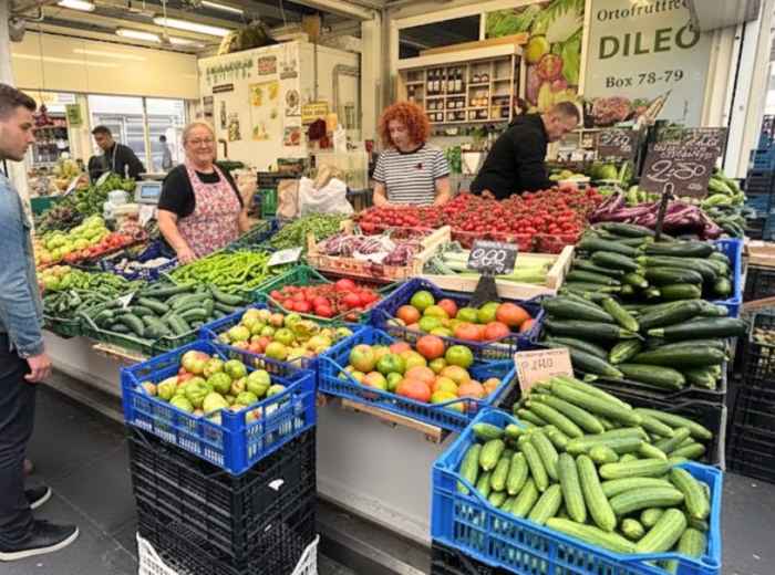 Testaccio Market at dawn with vendors arranging produce