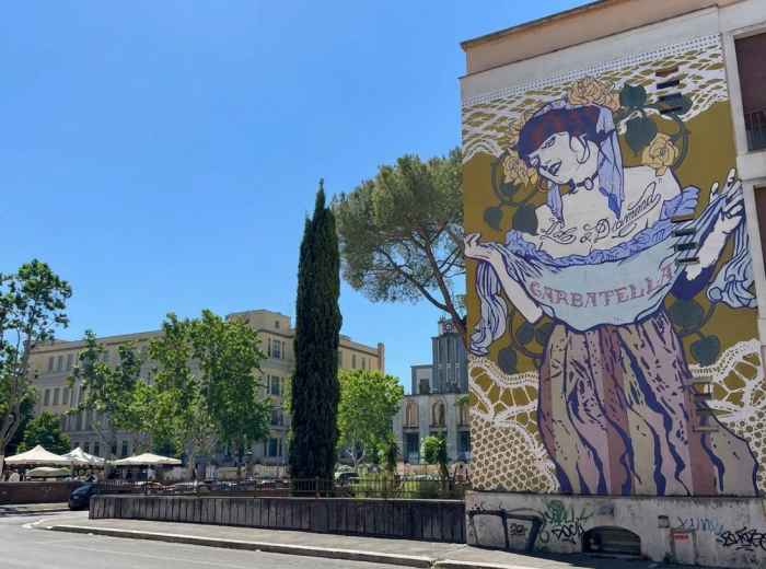 Garbatella mural overlooking a sunny square in Rome 