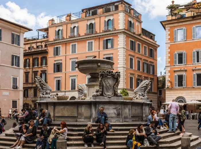 People relaxing around a lively piazza in central Rome 