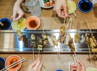 Travelers enjoying a multi course meal on a Kyoto food