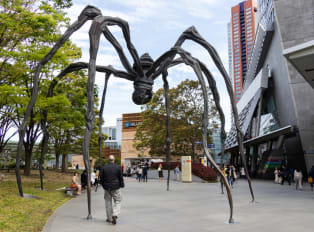 Tourist walking under a art piece, Mori Art Museum