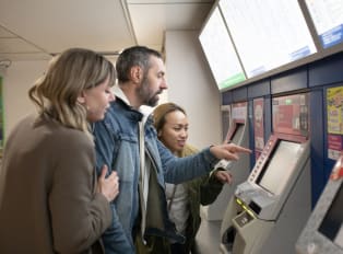 Tourists learning how to navigate the Tokyo from a loca
