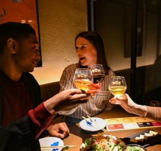 Travelers enjoying food with a local host in Kyoto, Jap