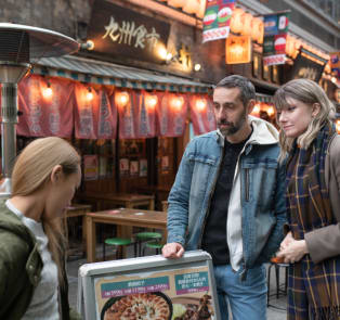 Couple with a local guide in a alley
