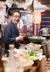 kobe beef tours Tourists enjoying a busy local restaurant in Tokyo with a local