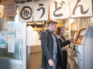 Tourists booking their bus home after a tour in Tokyo,